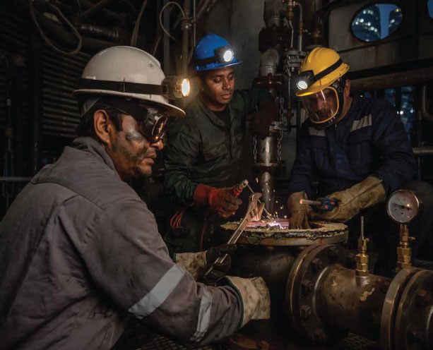 Industrial technicians repairing pipeline system