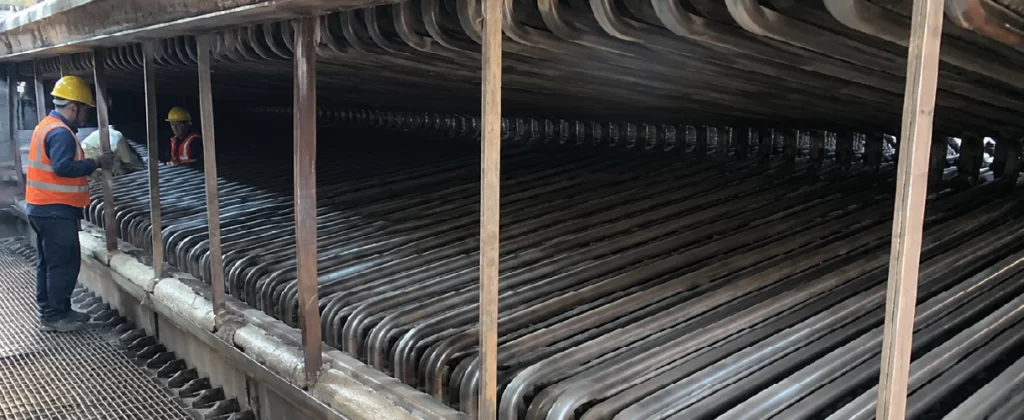 Industrial Heat Exchanger Tube Bundle Inspection by Maintenance Workers